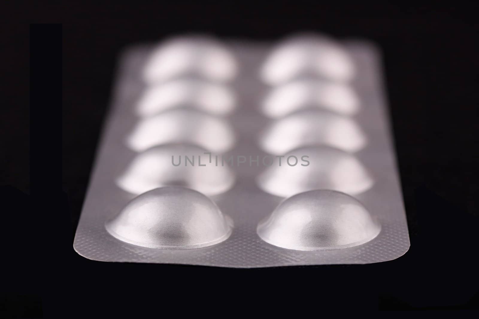 Tablets strip closeup on a black background by mnsanthoshkumar