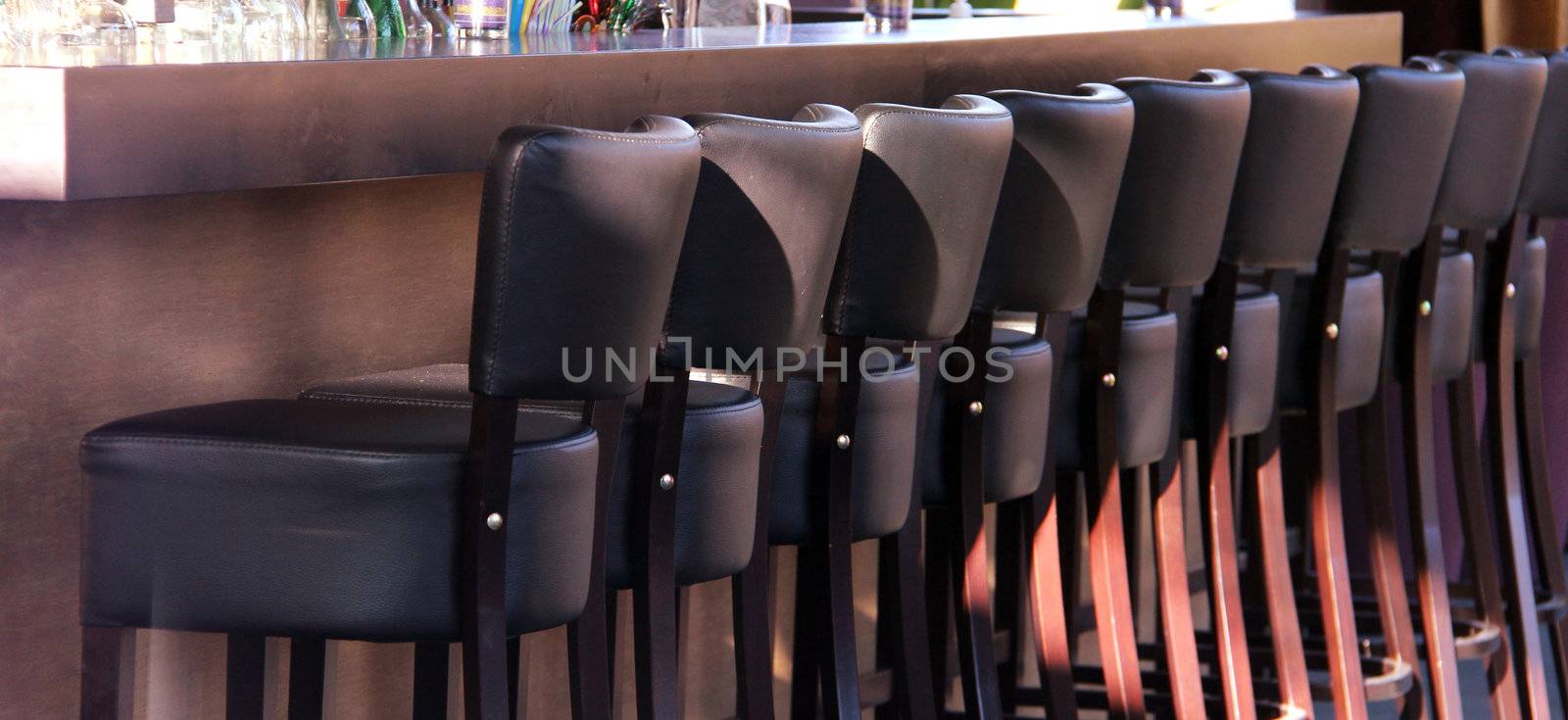 Many bar seats with leather in a row