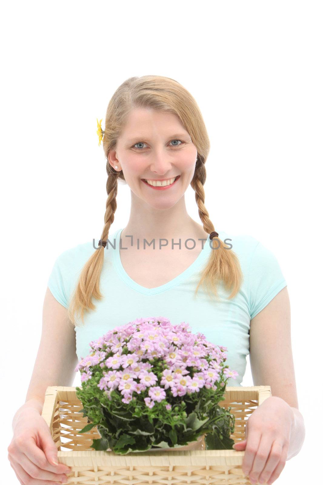 Studio shot of attractive young female who is holding flowers on white background