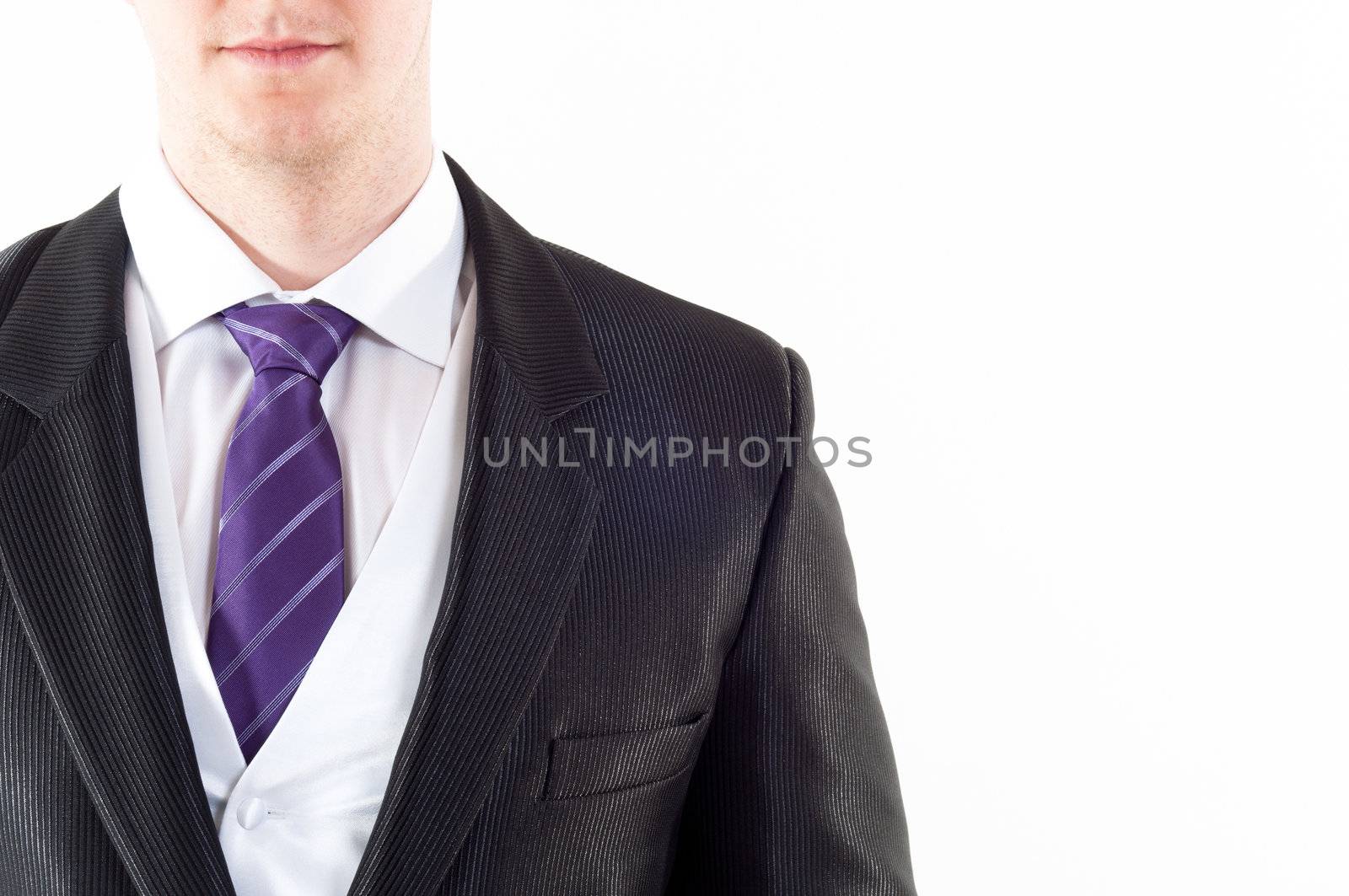Young buisnessman with purple tie on white background