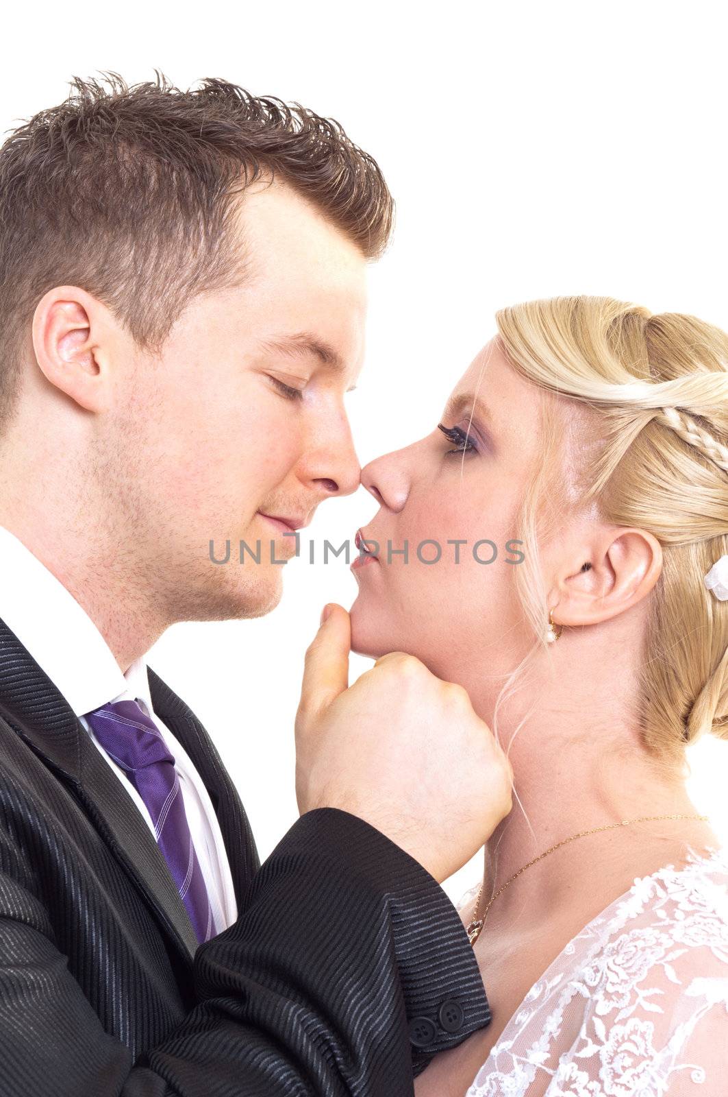 A couple on their wedding day kissing and laughing