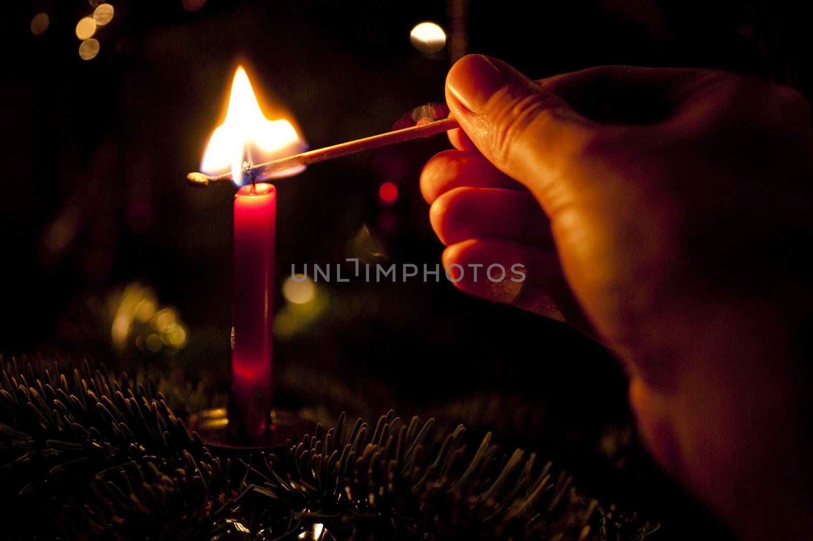 close up of a candle on a christmas tree