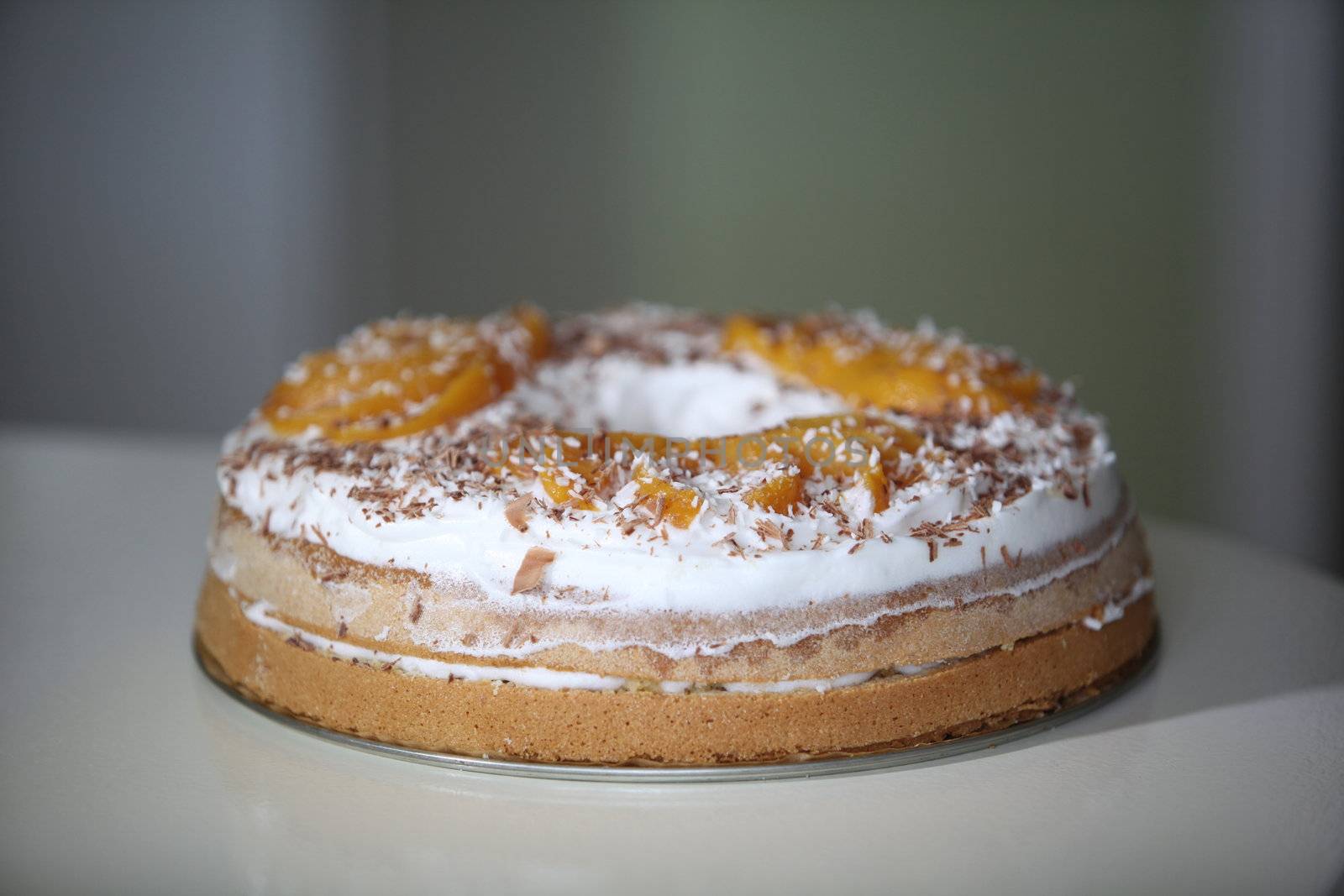 sponge cake with apricot cream and grated chocolate