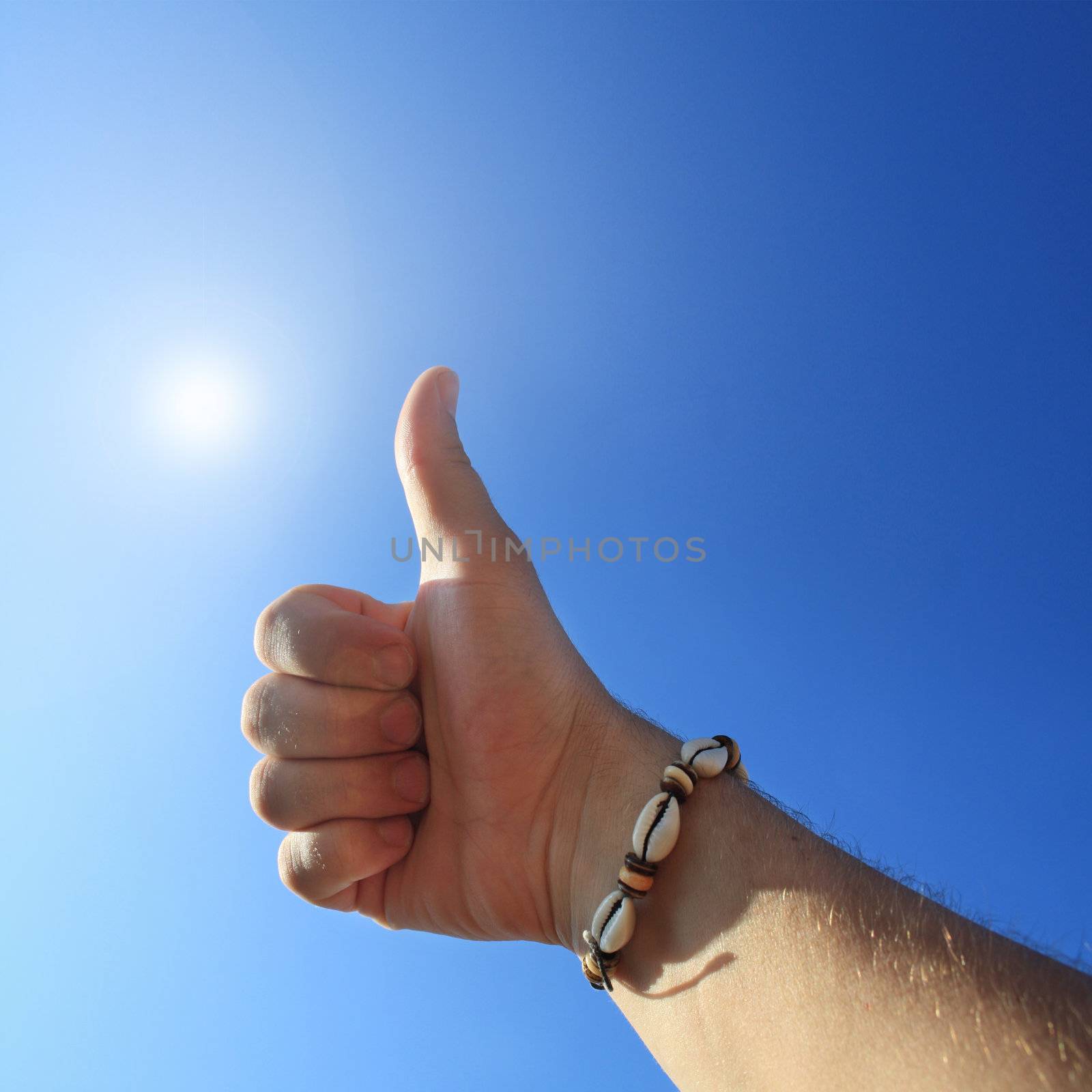 men's hand make thumbs up on blue sky