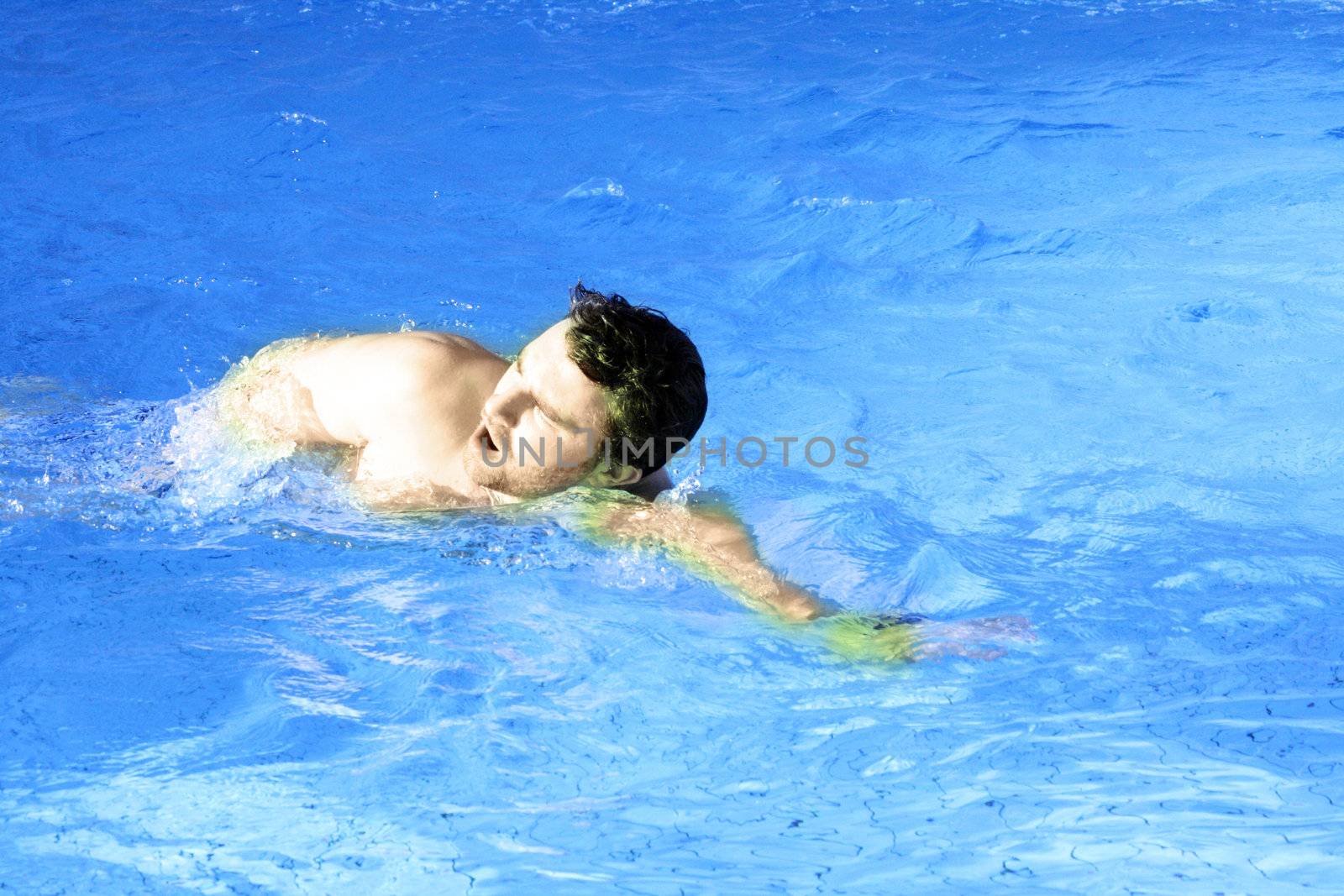 young sports swimmer in pool by photochecker