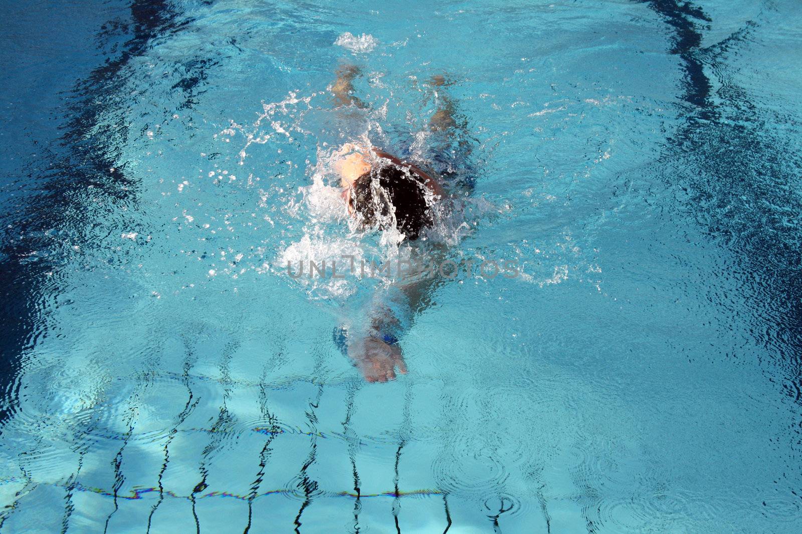 man swims in swimming pool