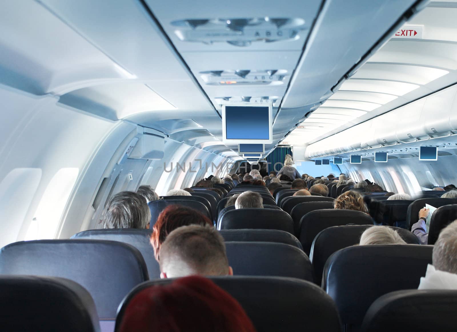 Passengers in airplane cabin interior by anterovium