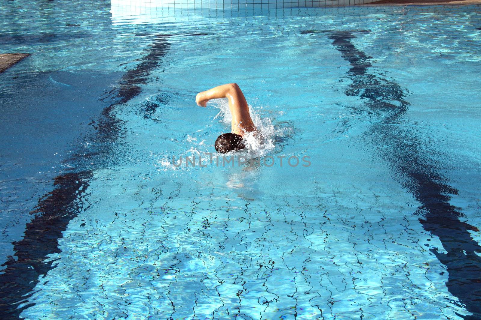a man learn swim the crawl in pool by photochecker