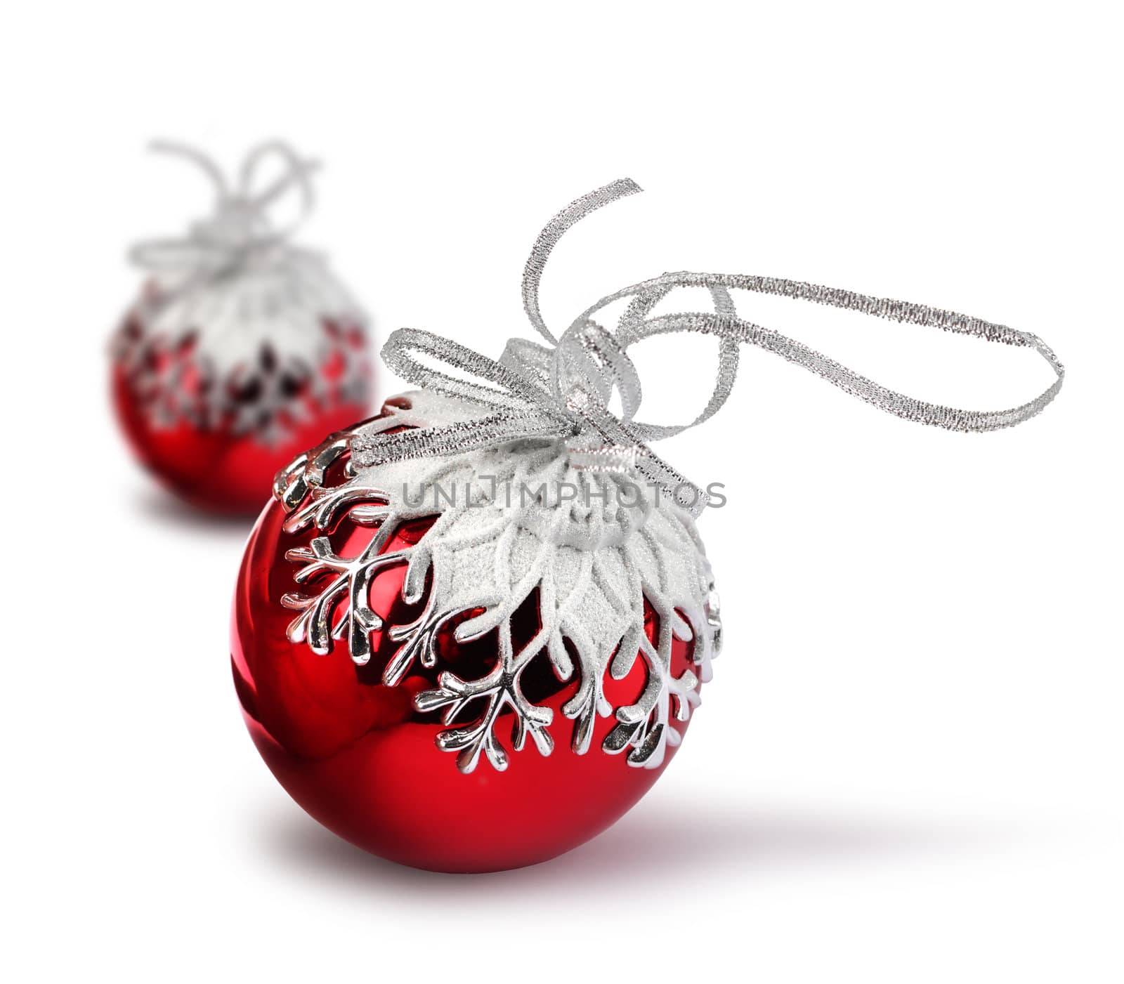 Two red Christmas balls with snowflake decoration, isolated on white