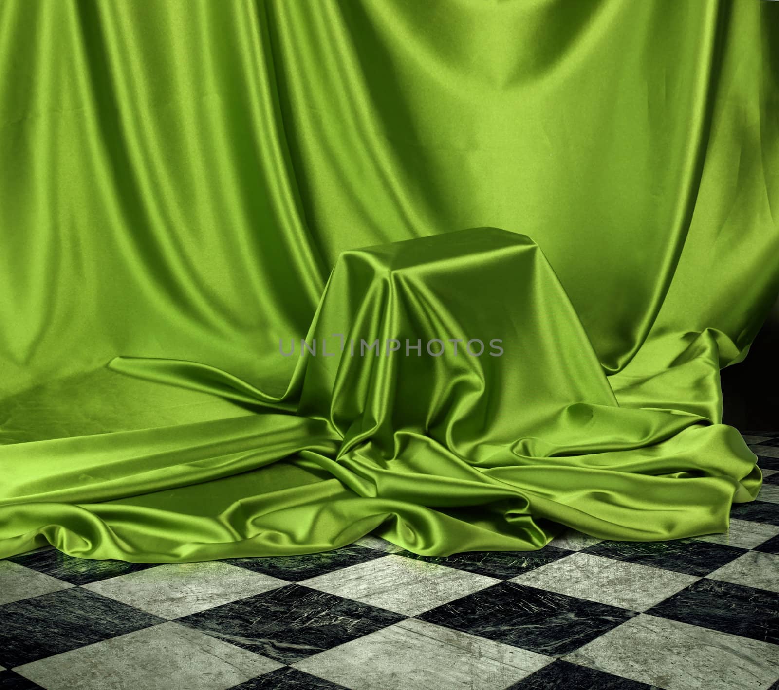 Something secret veiled under green satin silky cloth fabric