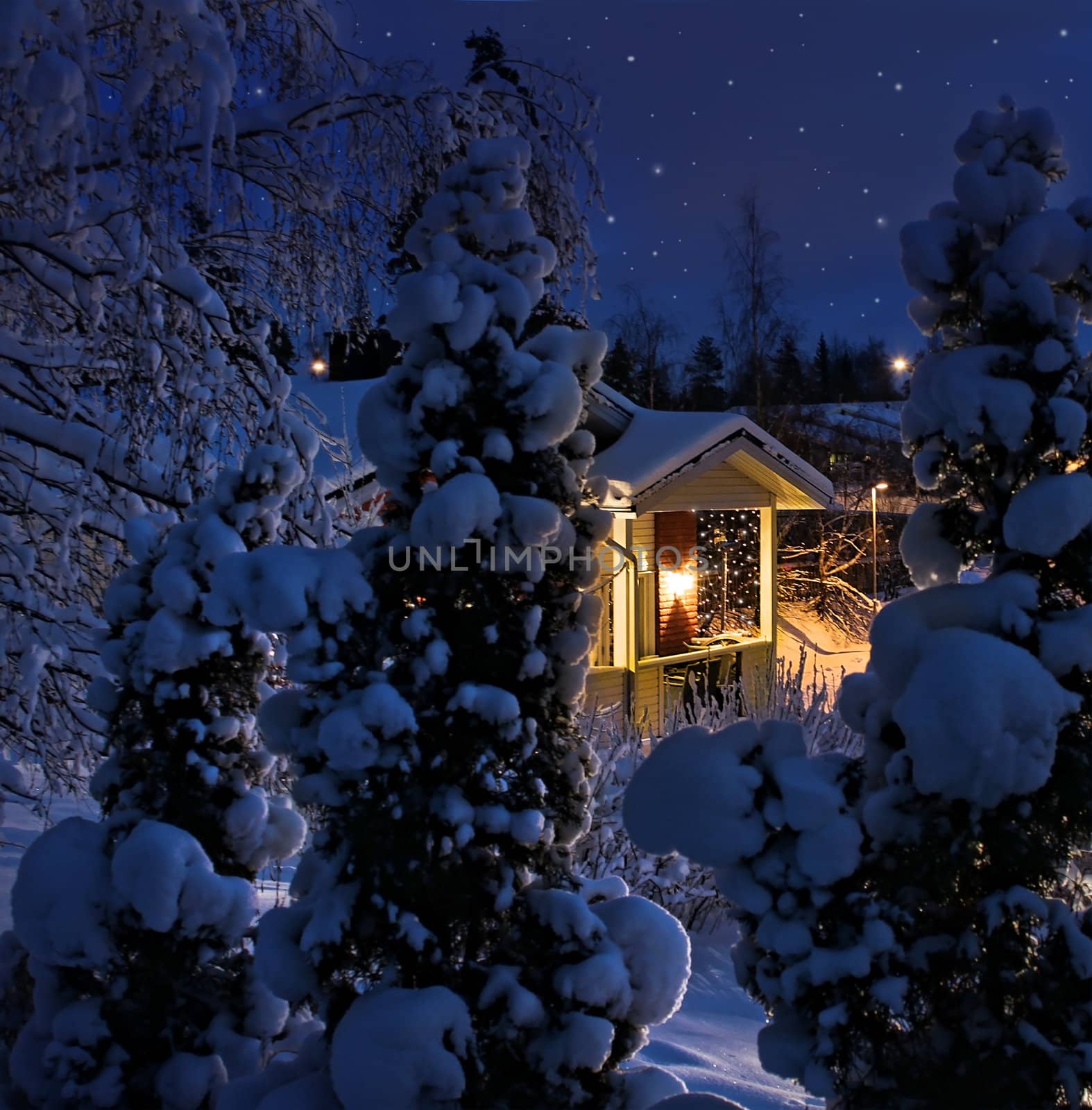 Illuminated house on snowy Christmas winter evening blue moment
