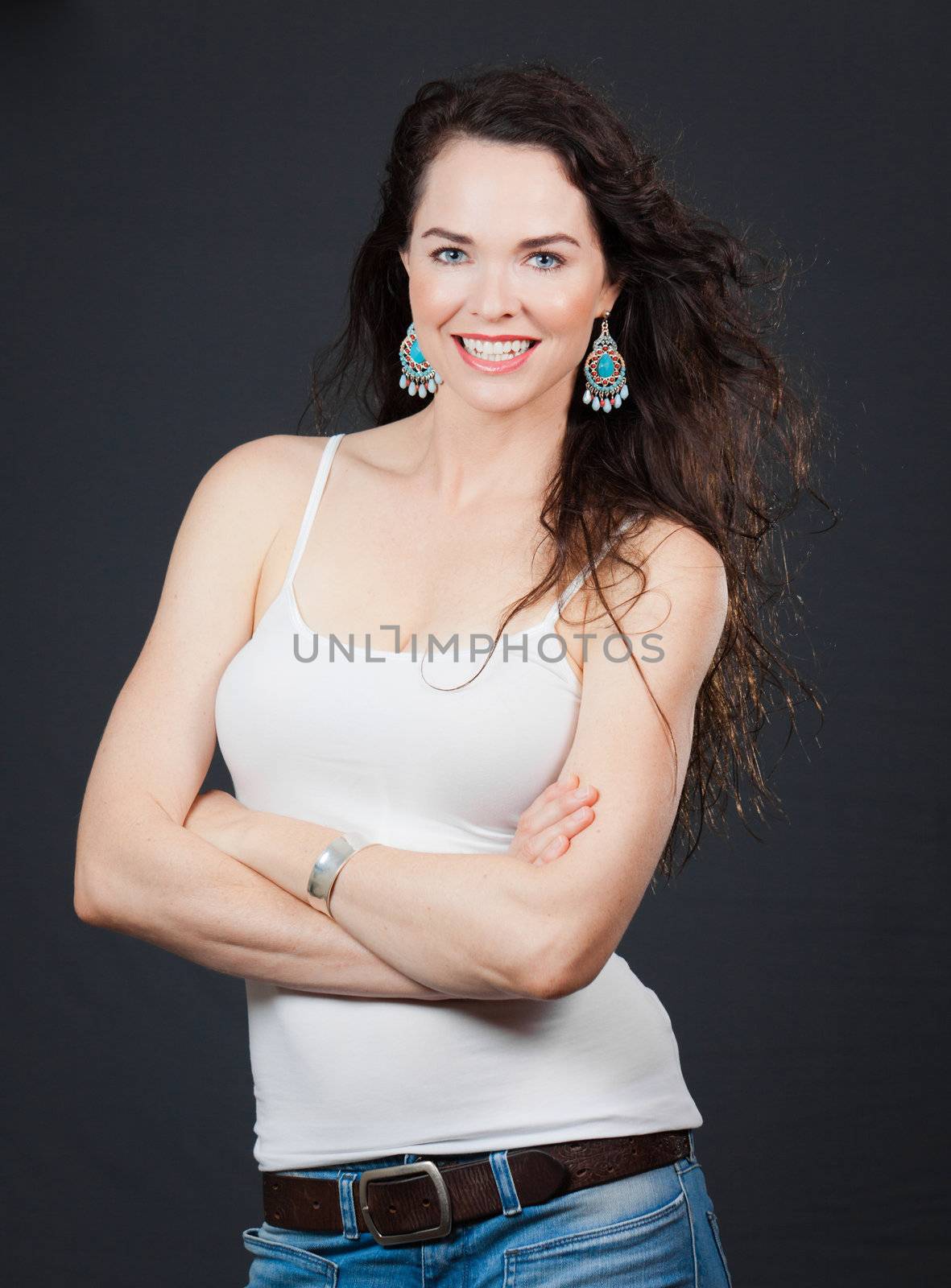 Portrait of a beautiful young confident woman, over grey background