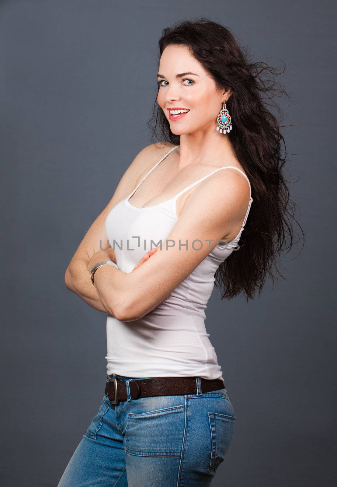 A portrait of a young beautiful woman wearing jeans and singlet