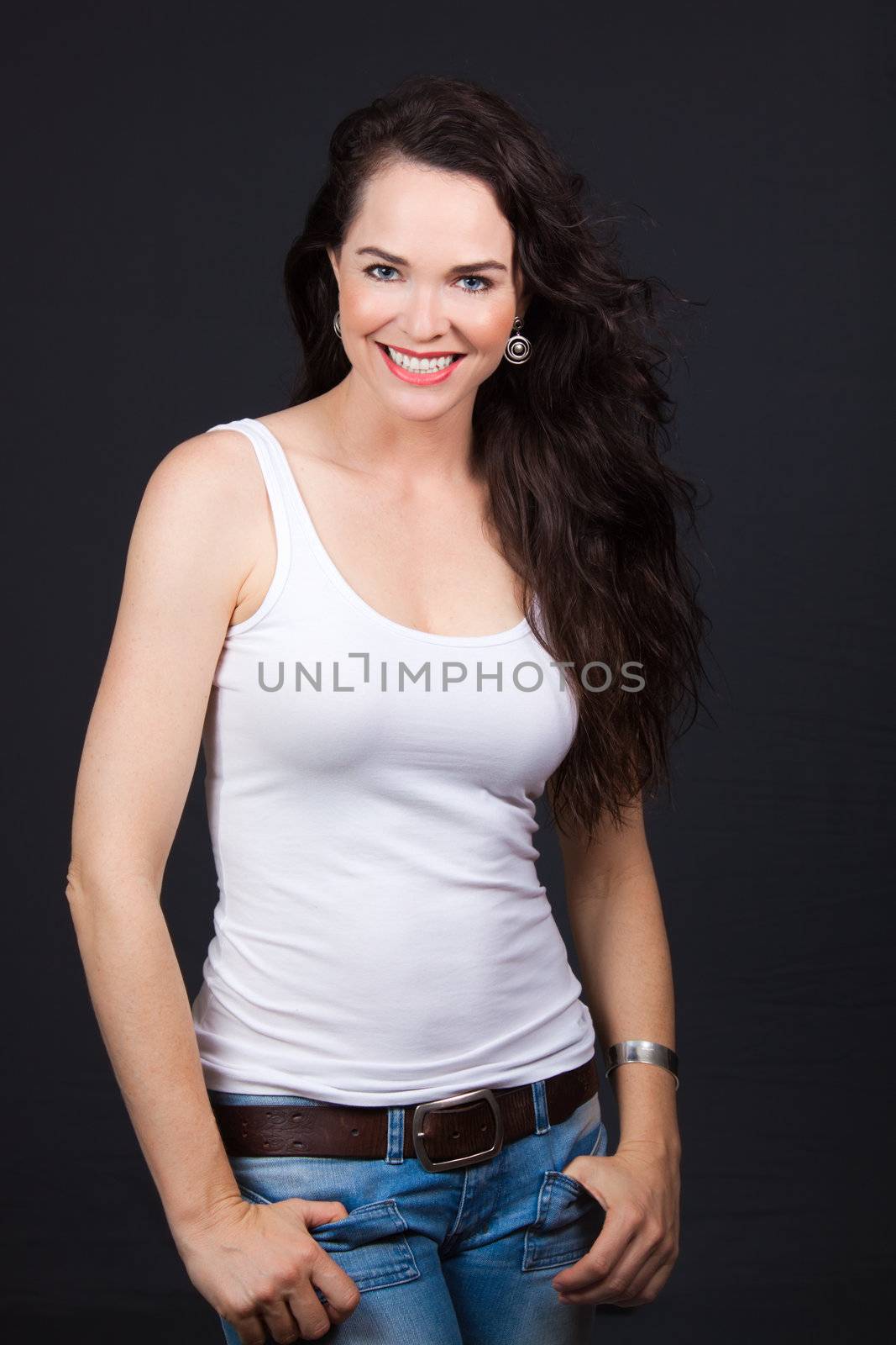 Young beautiful smiling confident woman, over grey background