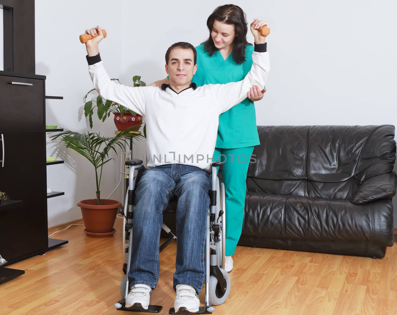 Physical therapist working with patient by manaemedia