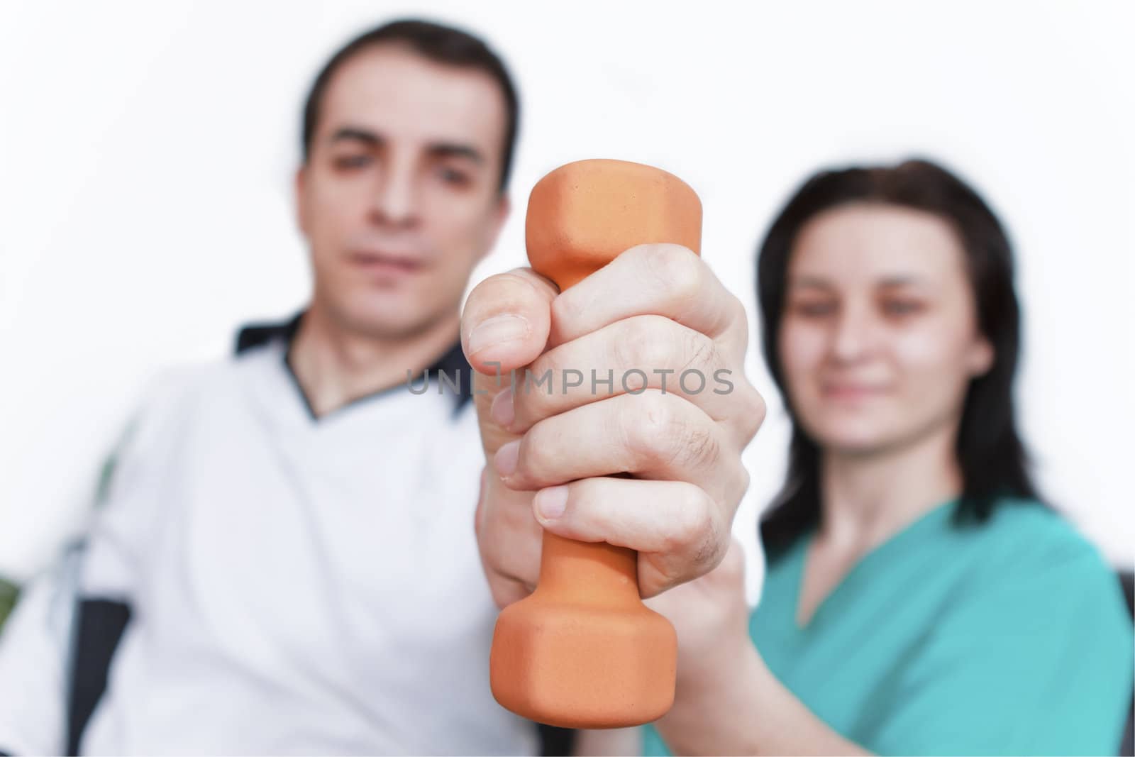 Physical therapist working with patient by manaemedia