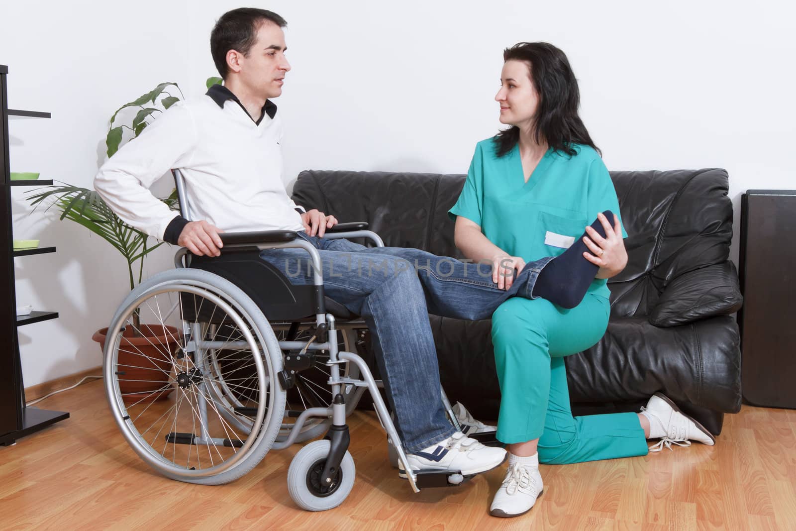 Physical therapist working with patient by manaemedia