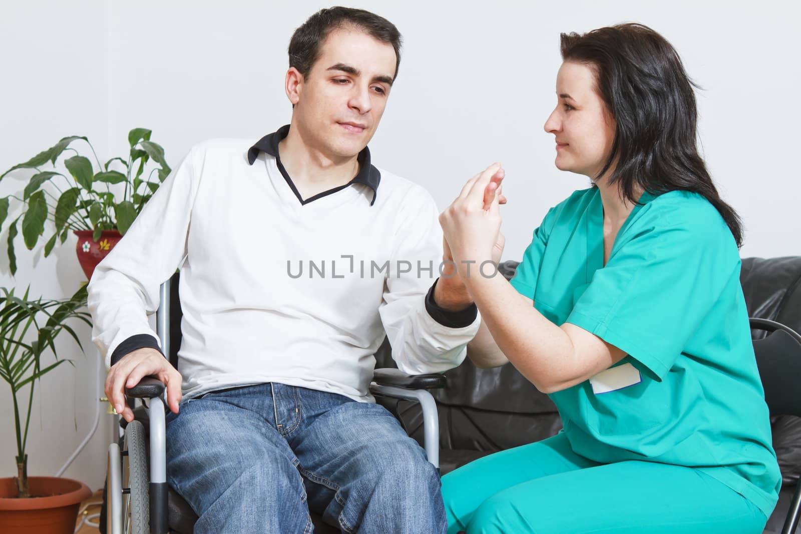 Physical therapist working with patient by manaemedia