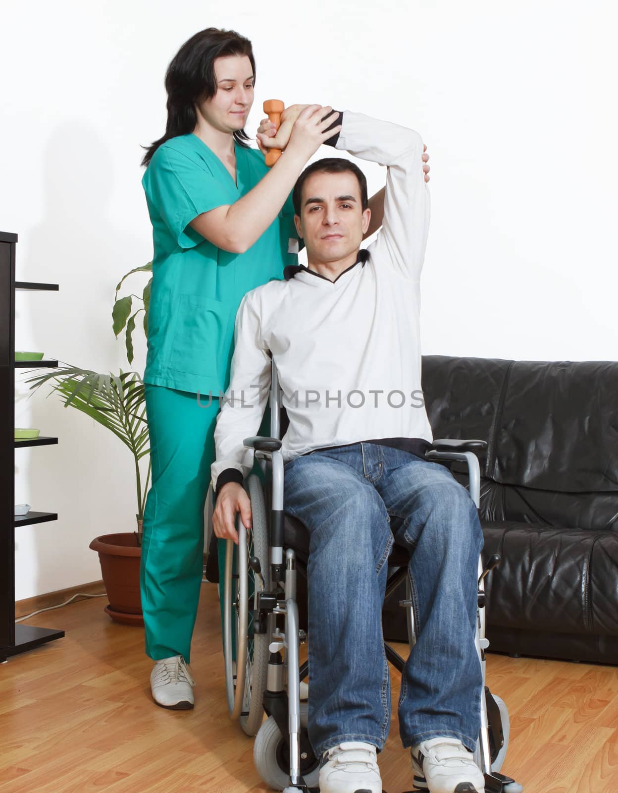 Physical therapist working with patient by manaemedia