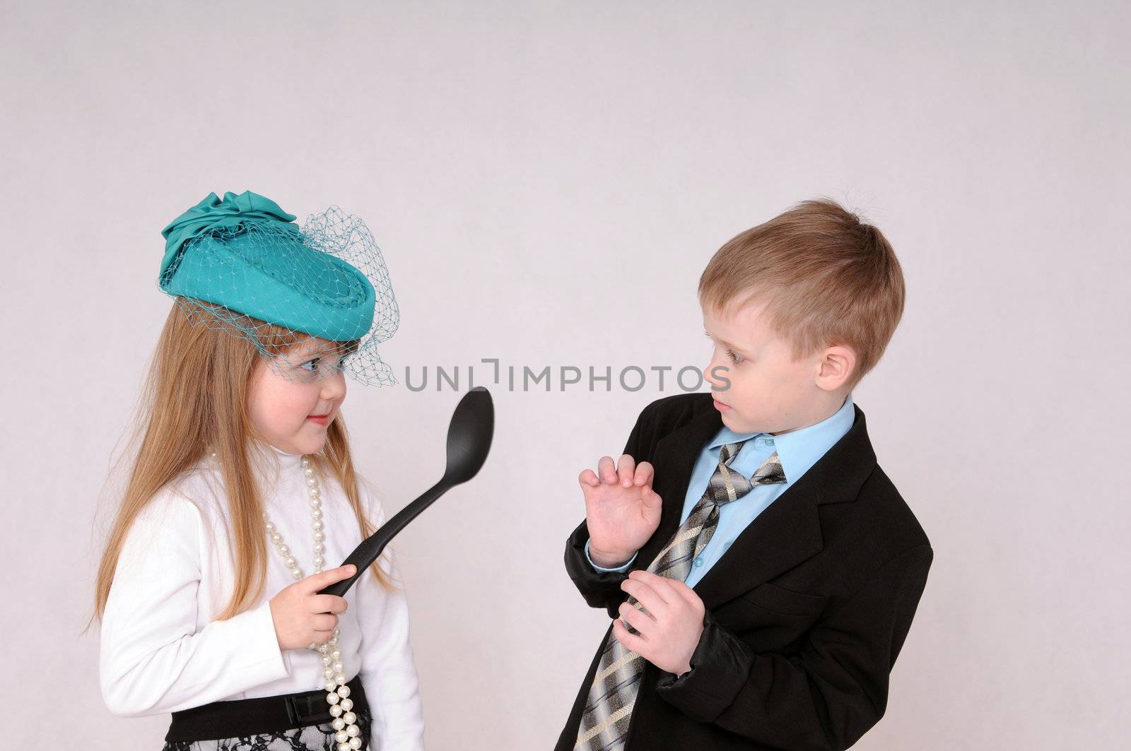Girl with a large spoon quarrel with a boy