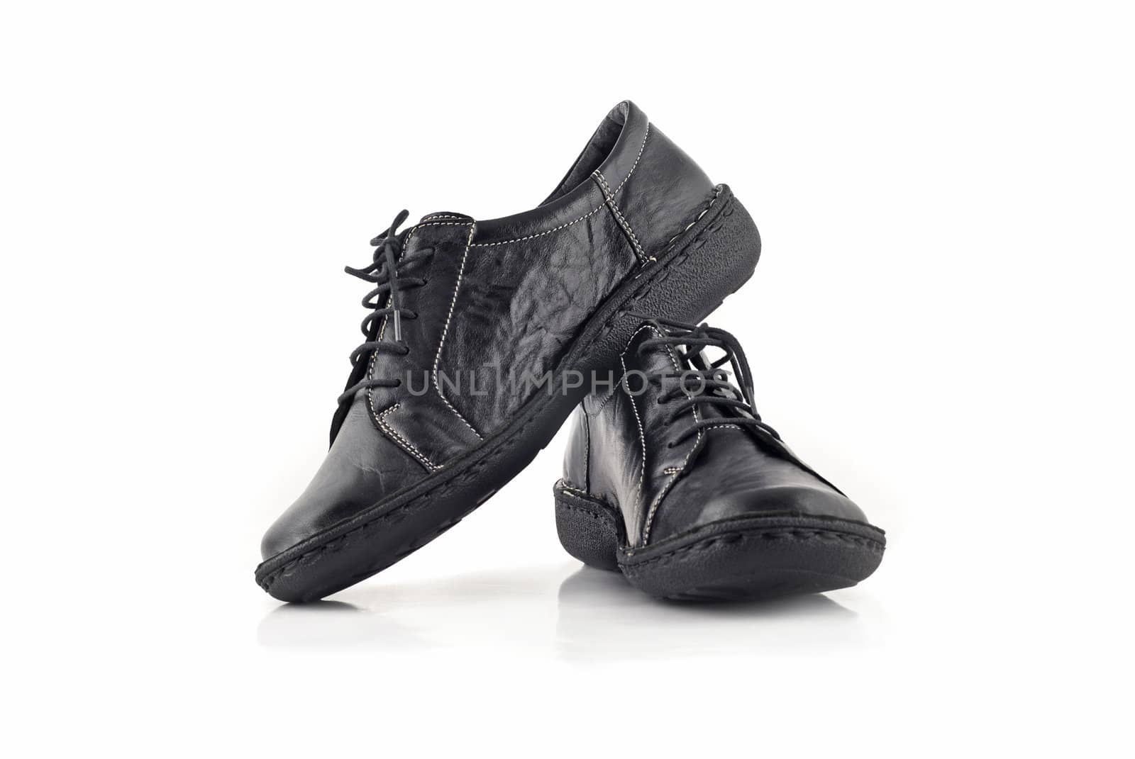 Pair of black leather women's shoes over white background