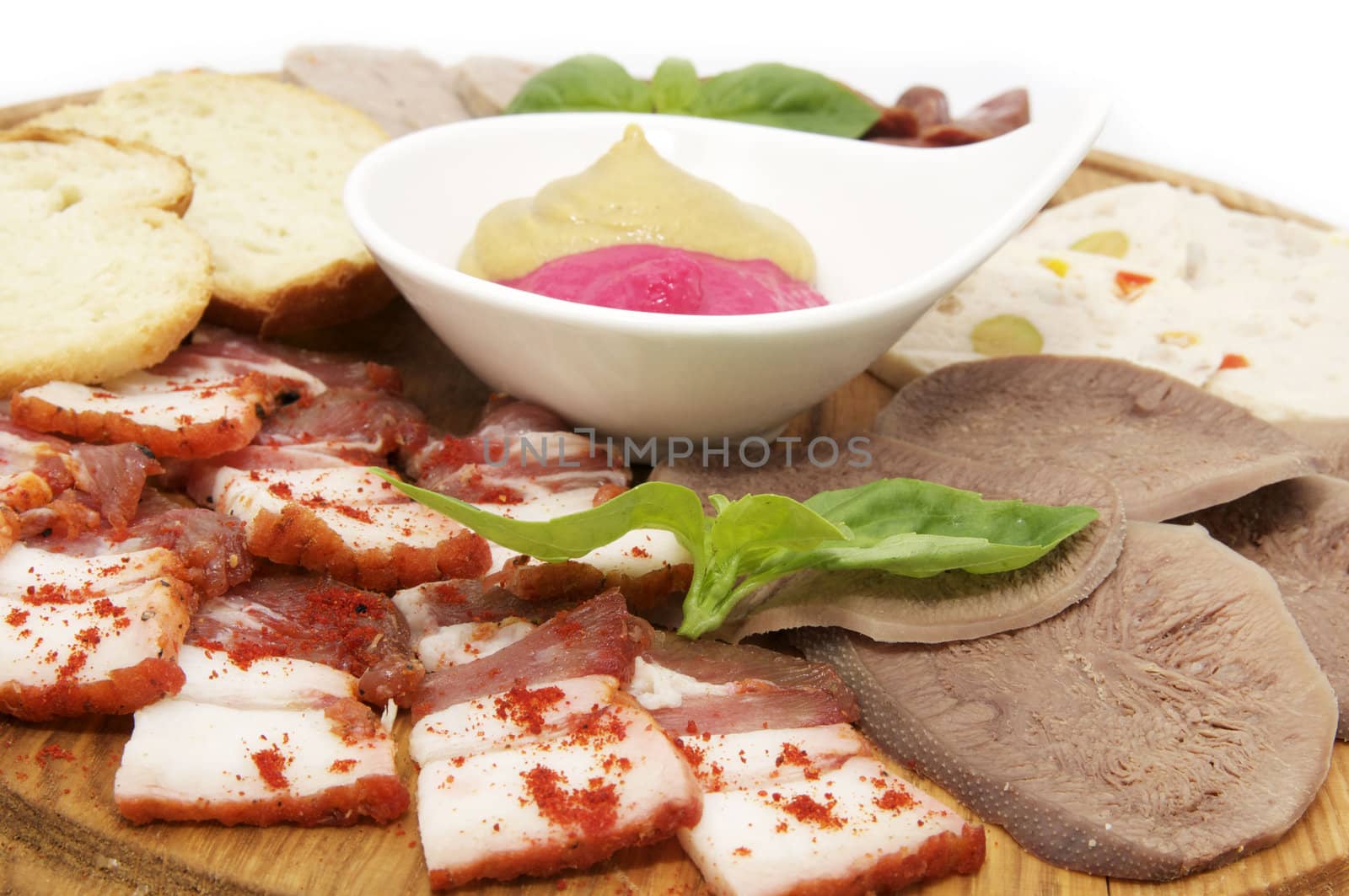 a plate of bacon and sausage on a white background