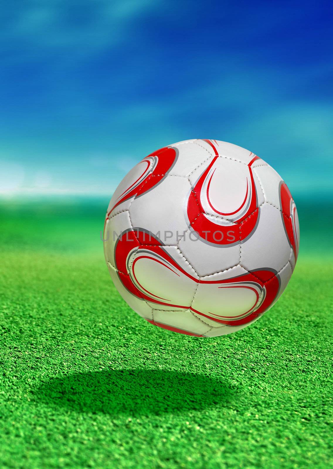 soccer ball on green ground in motion with path