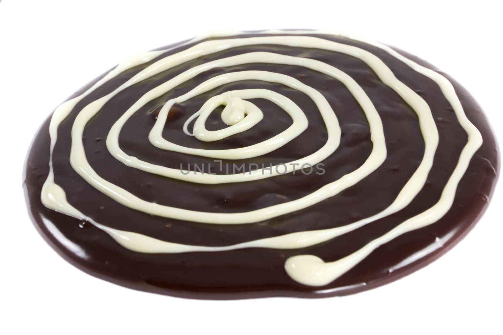 Picture of melted chocolate on a white background with white chocolate on it