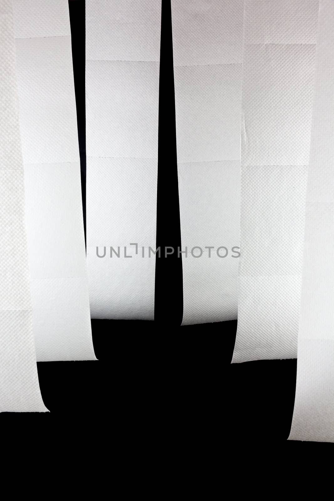 Picture of six hanging toilet papers on a black background