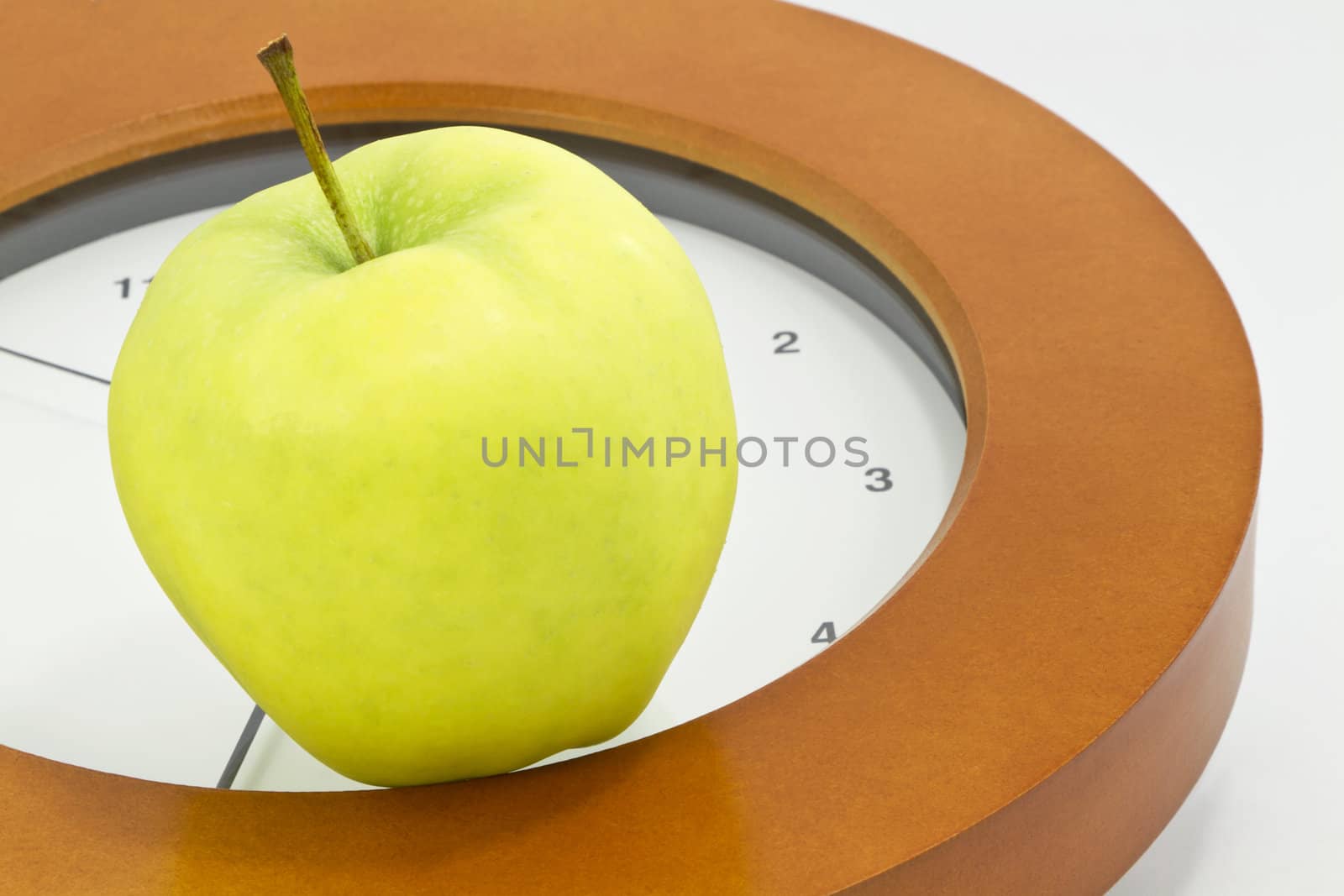 Golden, delicious apple placed on face of clock indicates that now is the time to face school, teacher, and education issues and policy changes in public, private, and charter schools; 