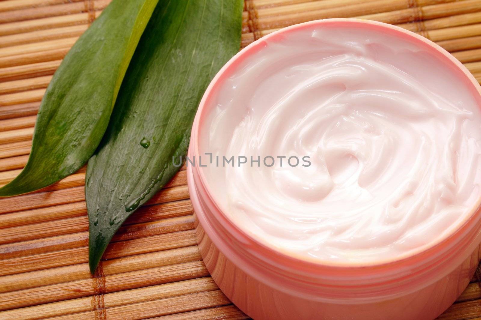 cosmetic cream against a background of bamboo