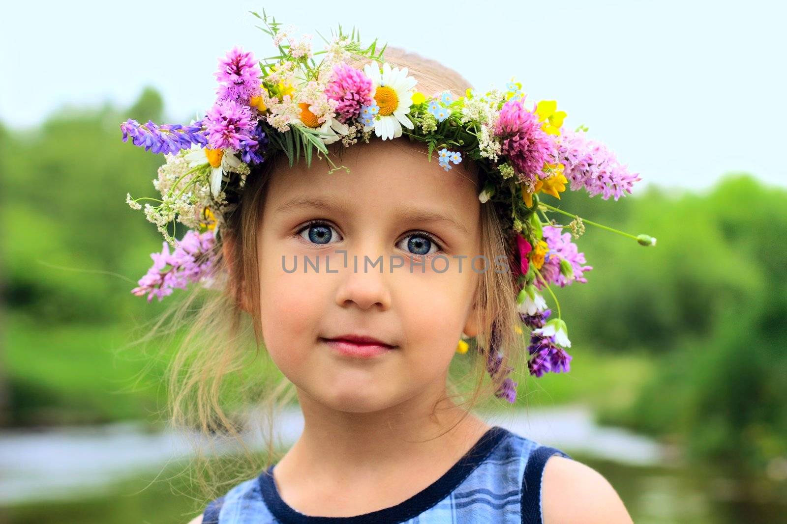 girl in the wreath with a bouquet of daisies.