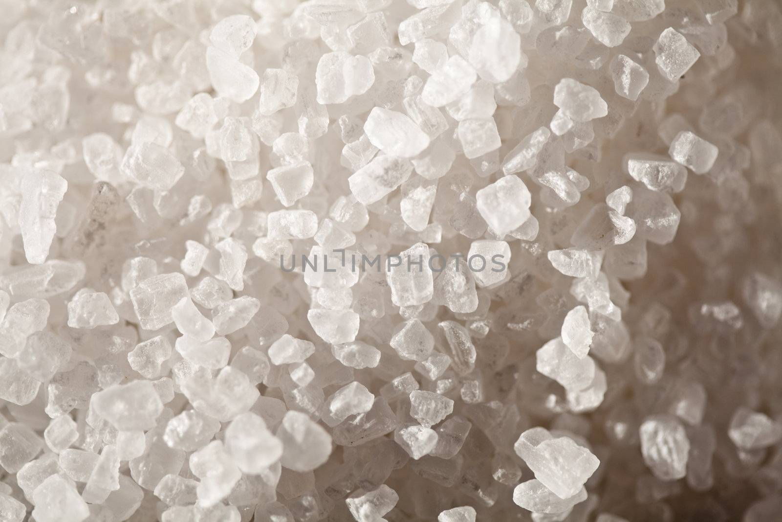 Crystals of of table salt in close-up, side lighting