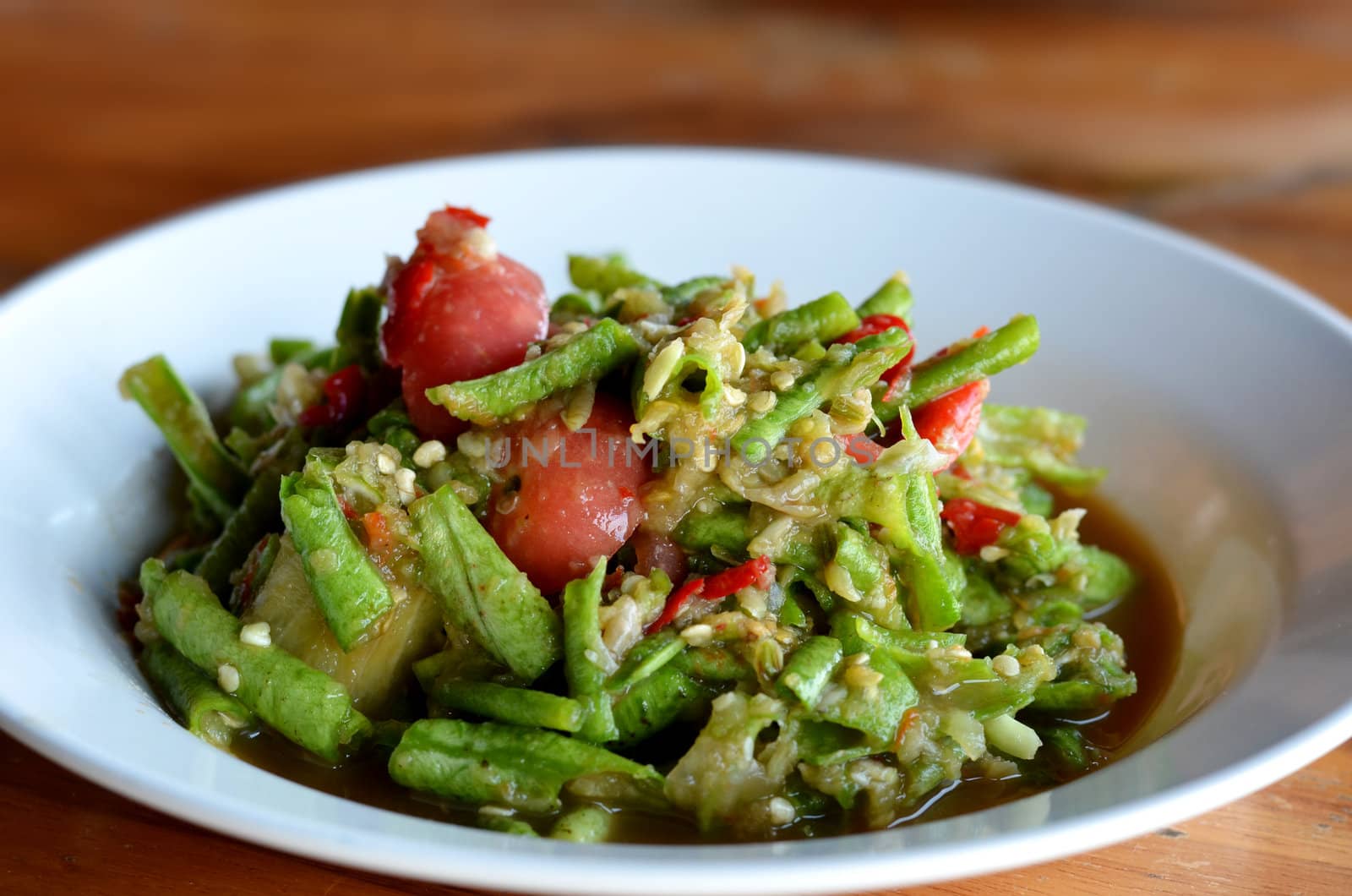 String bean spicy salad on white dish