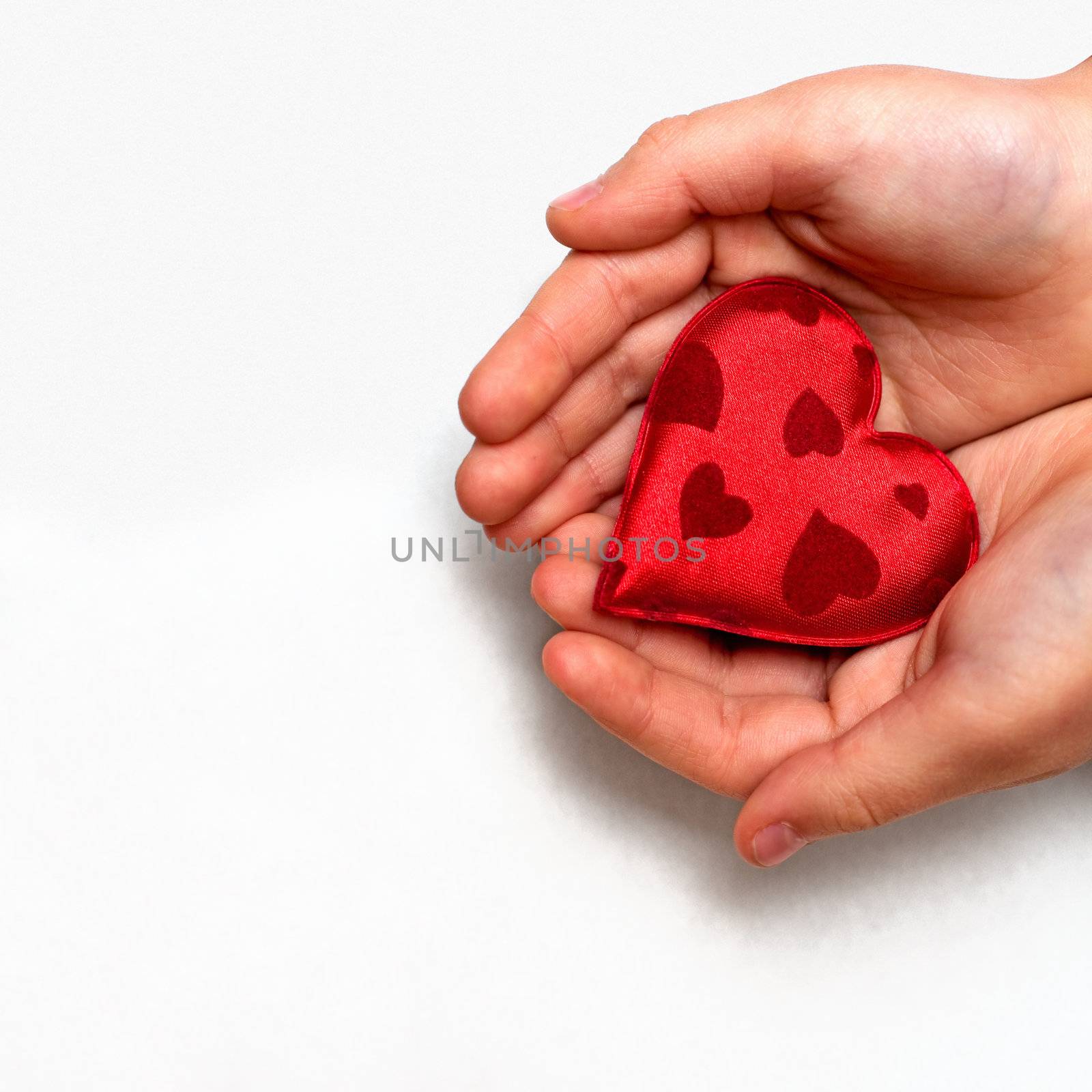 two hands holding a red heart