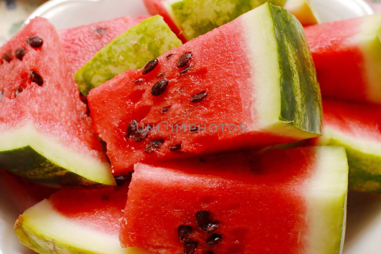 Juicy watermelon. Background of brightly lit watermelon slices.
