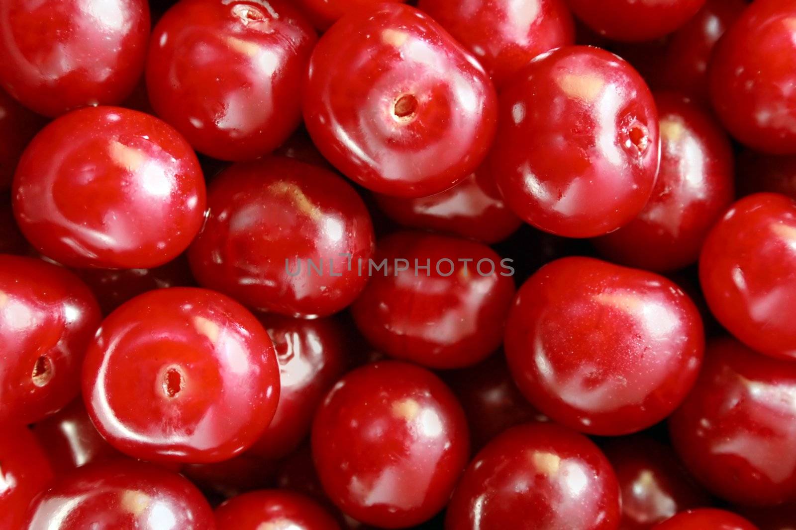 a lot of fresh cherries in a plate