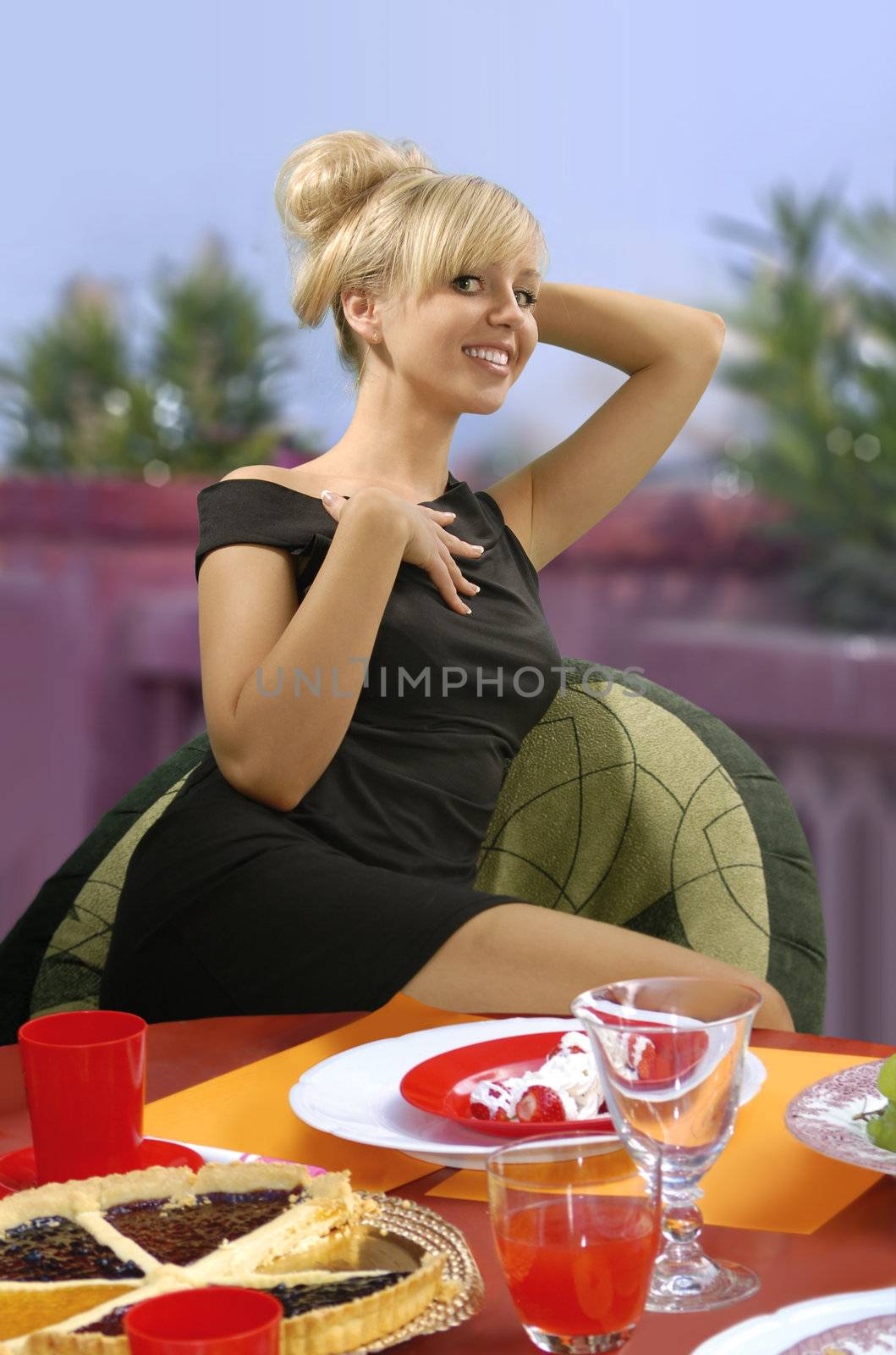 beautiful young woman sitting in a cafe eating cake