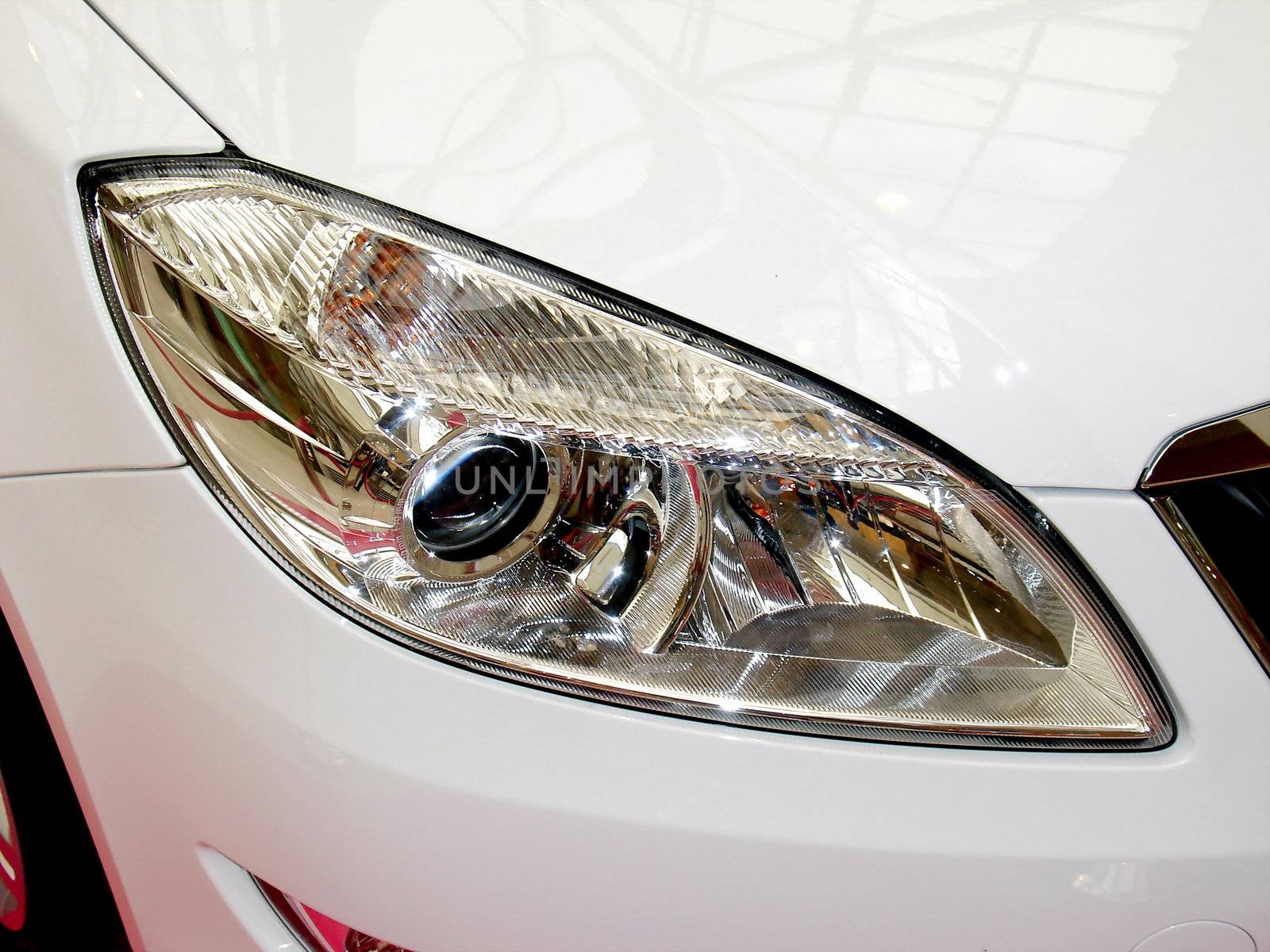 Headlight of the white Skoda Fabia car