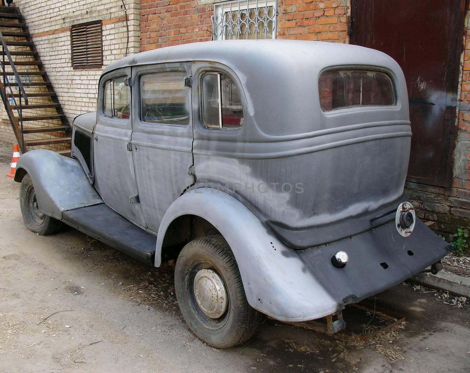 Vintage old German car on a brick wall background