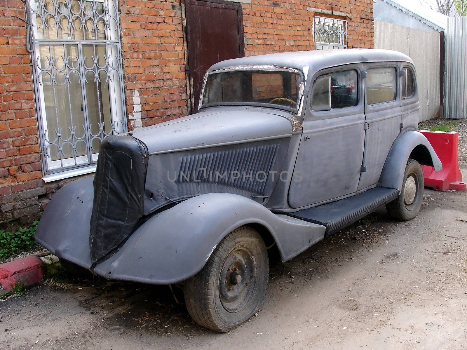 Vintage old German car on a brick wall background