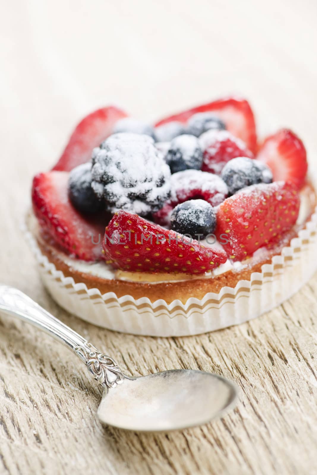 Fruit tart with spoon by elenathewise