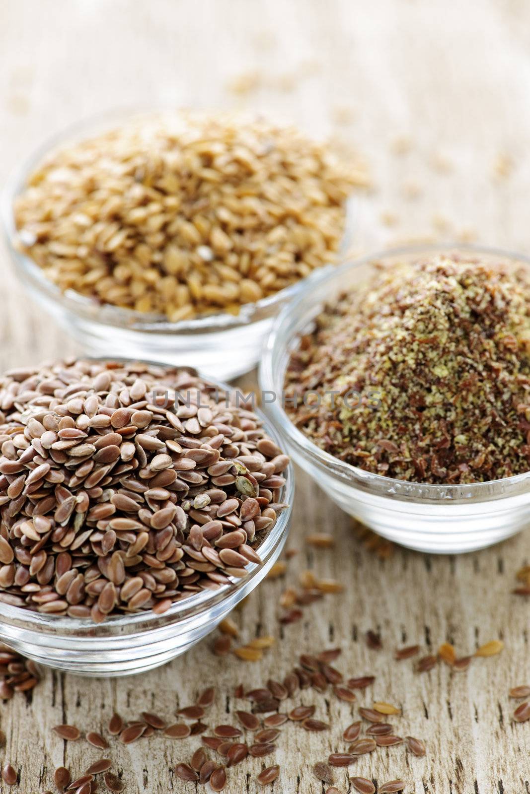 Bowls of whole and ground flax seed or linseed