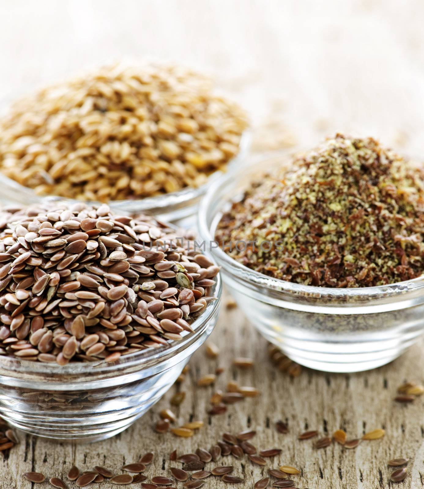 Bowls of whole and ground flax seed or linseed