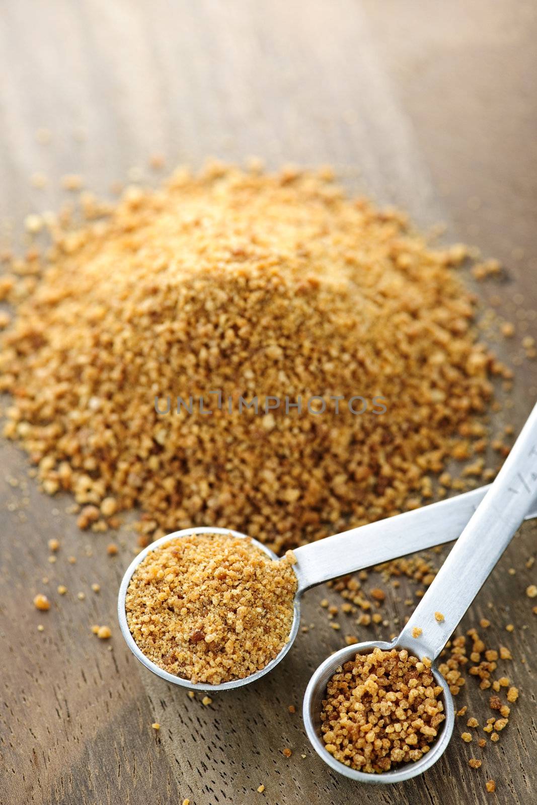 Coconut palm sugar in measuring spoons by elenathewise
