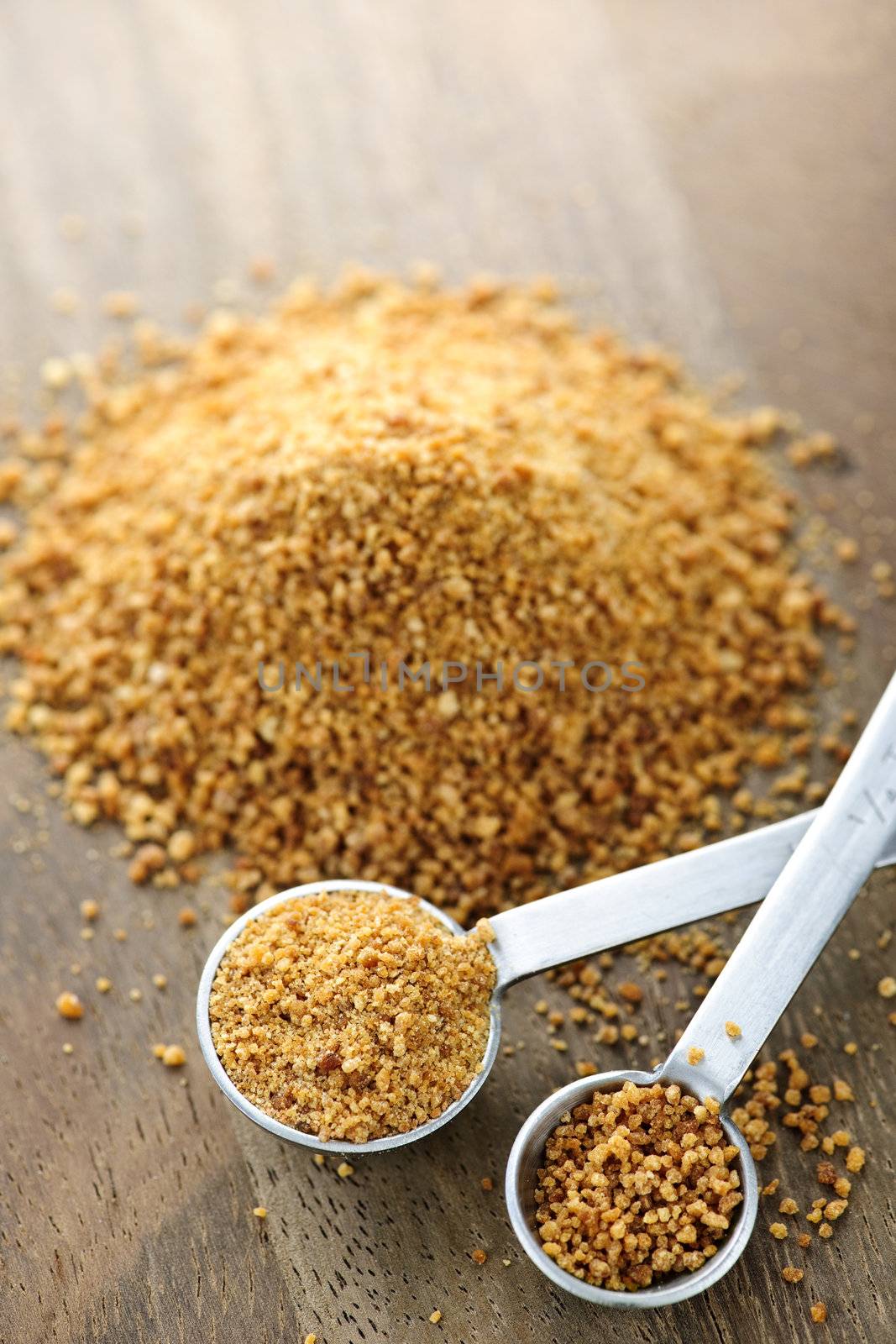 Organic coconut palm sugar in measuring spoons