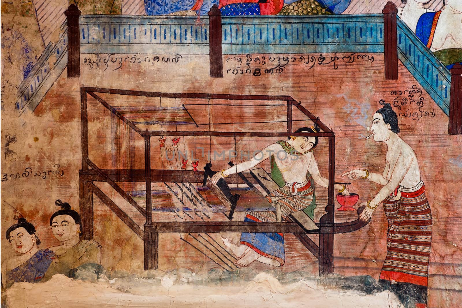 Ancient Buddhist temple mural depicting a Thai daily life scene at Wat Phumin, a famous temple in Nan province, Thailand. The temple is open to the public and has beautiful murals on the walls.