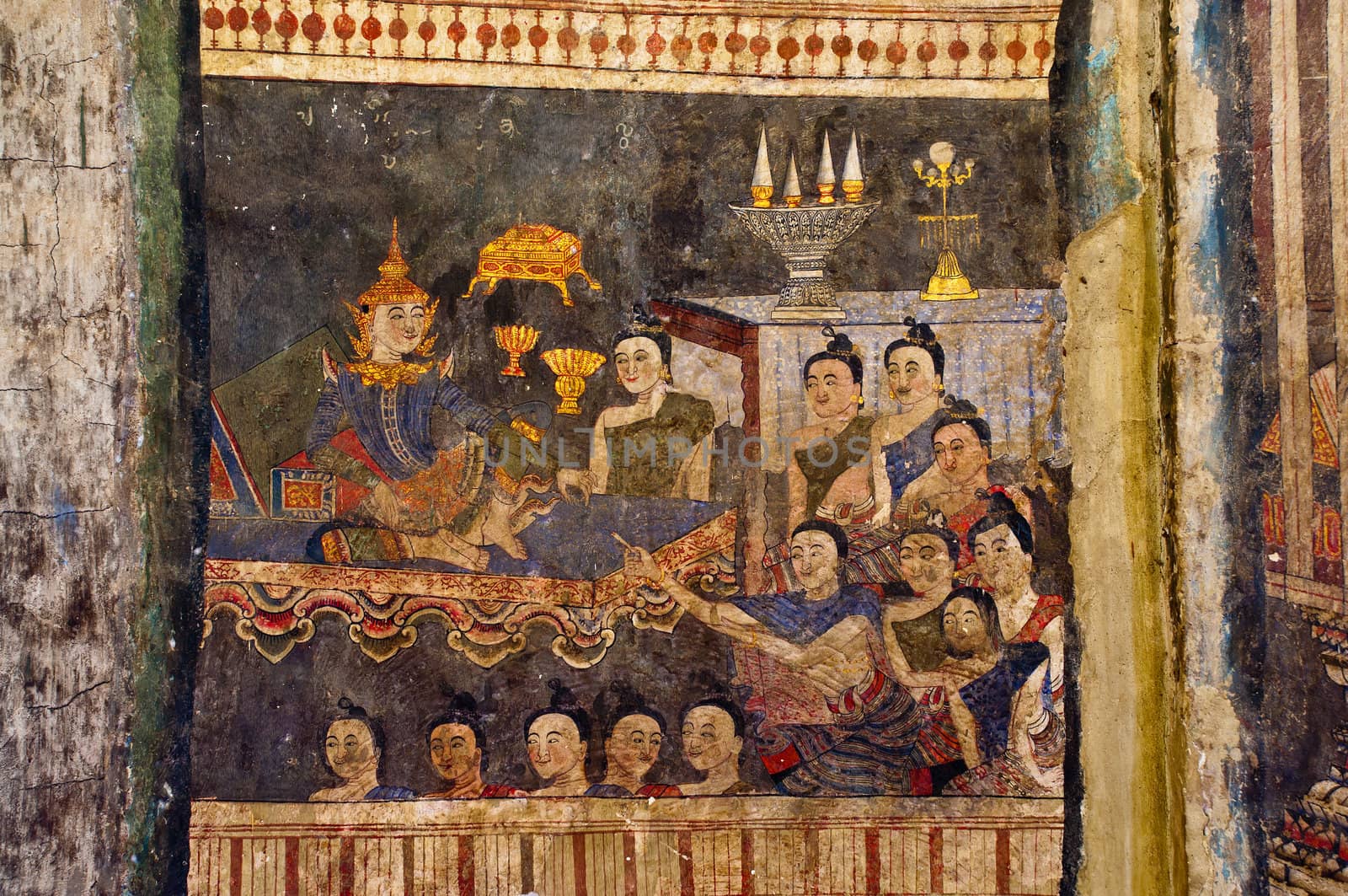 Ancient Buddhist temple mural depicting a Thai daily life scene at Wat Phumin, a famous temple in Nan province, Thailand. The temple is open to the public and has beautiful murals on the walls.