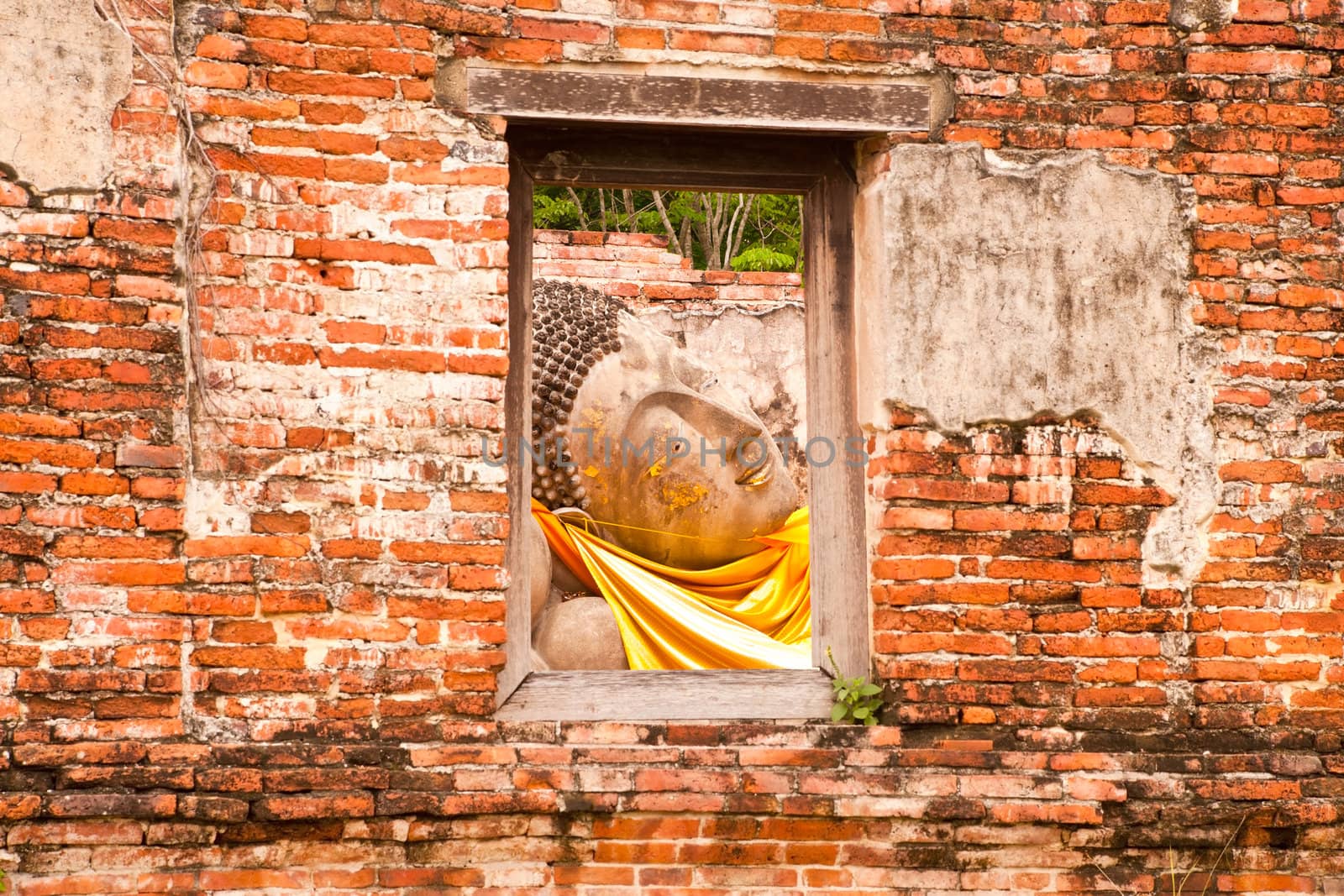 Sleeping Buddha Statue in Window at Wat Putthaisawan Temple Ayutthaya , Thailand.