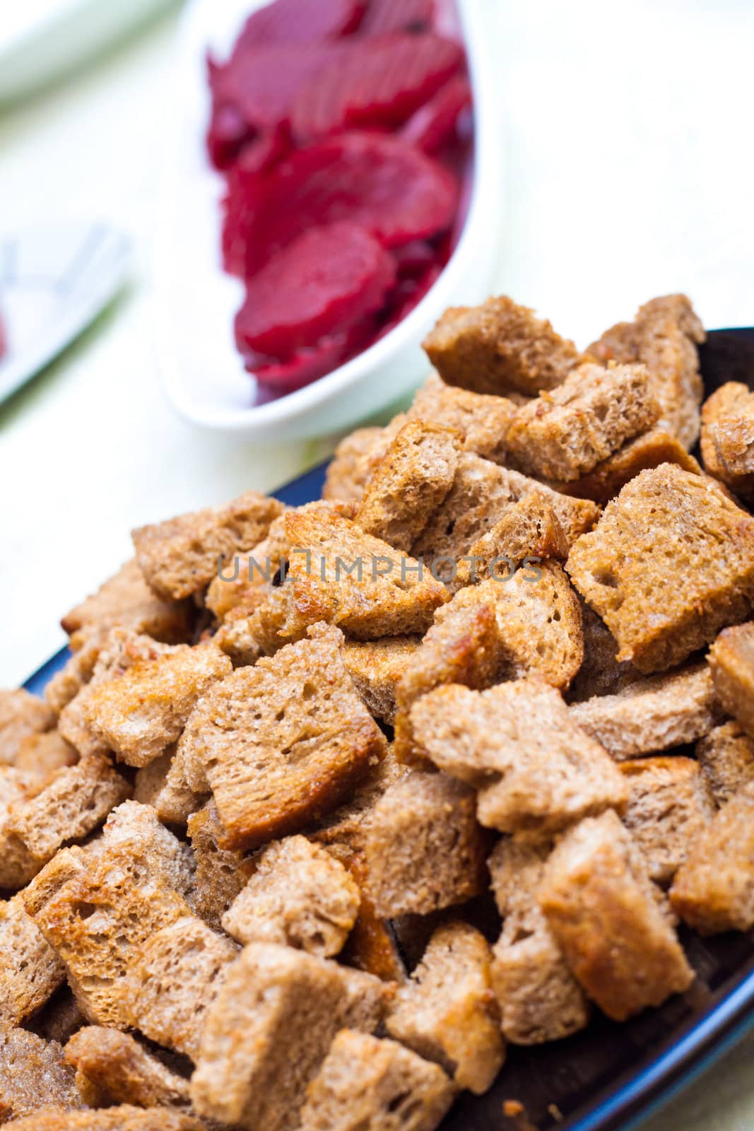 Closee up of croutons with beet in the backgroung by Lamarinx